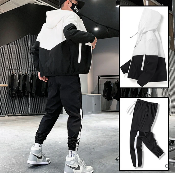 Zwart-wit trainingspak voor heren, bestaande uit een hoodie en joggingbroek. Ideaal voor sport en casual streetwear. Comfortabel en stijlvol ontwerp.