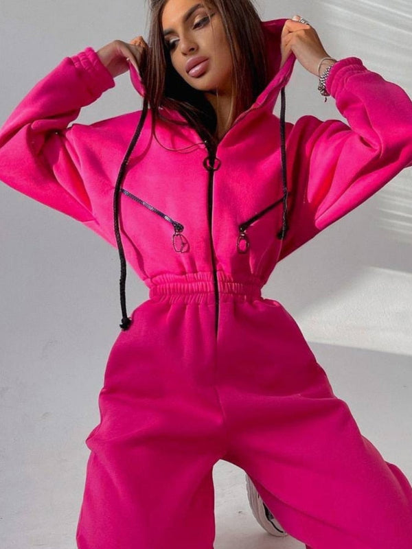 Jonge vrouw in felroze hoodie en joggingbroek, modieuze streetwear, comfortabele sportkleding, trendy outfit voor casual stijl.