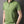 Groene polo met ritssluiting, korte mouwen en opstaande kraag, gedragen door een man. Stijlvolle herenkleding, casual en modern design.