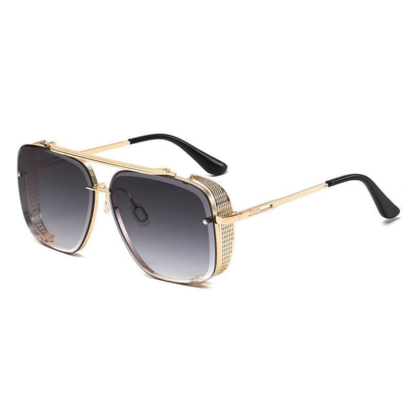 Gouden piloten zonnebril met grijze gradient lenzen en zwart-witte pootjes, modieus en stijlvol accessoire voor heren en dames.