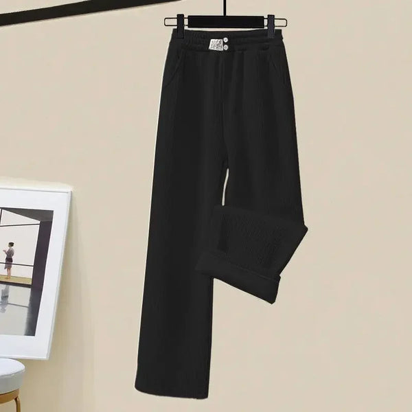 Zwarte damesbroek met wijde pijpen, hangend aan een hanger. Ideaal voor casual en zakelijke outfits. Comfortabele en stijlvolle modekeuze.