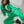 Vrouw in groene joggingpak met capuchon, zittend op witte achtergrond. Modieuze sportkleding, comfortabele loungewear, trendy damesmode.
