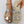Zilveren sandalen met hartvormige decoraties, gedragen op een beige zool. Perfect voor zomermode en casual outfits. Trendy dames schoeisel.