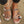 Zilveren sandalen met hartvormige decoraties op zandstrand, stijlvolle damesmode, zomerschoenen, trendy accessoires, casual strandlook.