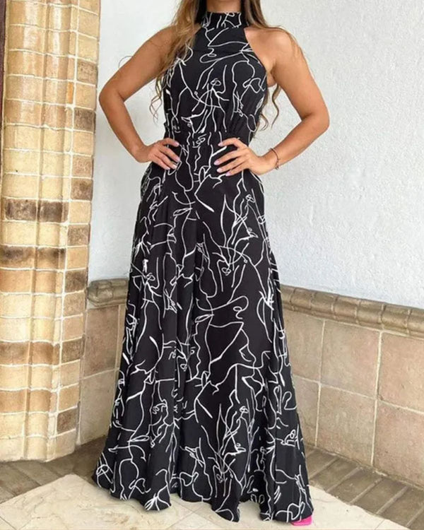 Zwarte maxi-jurk met witte abstracte lijnen, mouwloos en halternek, perfect voor zomerse evenementen en casual chique gelegenheden.