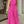 Roze jumpsuit met abstracte zwarte lijnen, halternek en wijde pijpen, gedragen door een vrouw. Perfect voor zomermode en trendy outfits.