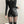 Vrouw in zwarte leren shorts en panty, modieuze outfit, trendy kleding, moderne stijl, minimalistisch design, comfortabele pasvorm.