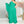 Vrouw in elegante, groene asymmetrische avondjurk met één schouder, staand in moderne interieursetting. Perfect voor galafeest of bruiloft.