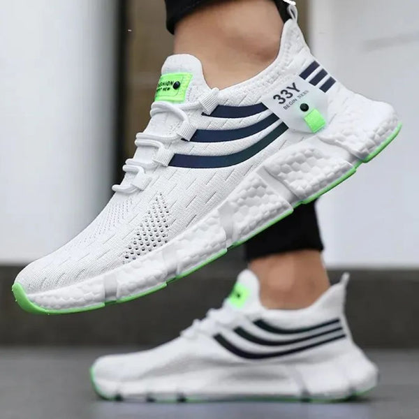 Witte sportschoenen met groene accenten, ademend mesh, comfortabele zool, geschikt voor hardlopen en fitness. Trendy en duurzaam ontwerp.