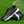 Zwarte tennisschoenen met witte driehoekige patronen op kunstgras, naast een tennisracket. Perfect voor sport en outdoor activiteiten.