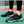 Tennisschoenen met zwart-wit geometrisch patroon op tennisbaan, naast racket. Comfortabele sportschoenen voor optimale prestaties.