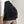 Zwarte corduroy minirok met zak, gedragen door model in witte trui. Modieuze dameskleding, herfst-winter stijl, trendy outfit.