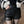 Vrouw draagt zwarte leren shorts met riemdetail, gecombineerd met zwart-witte bontjas. Modieuze winteroutfit, trendy dameskleding.