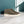 Grijze suède herenschoenen op marmeren vloer, tegen een blauwe muur. Stijlvolle casual schoenen, perfect voor moderne herenkleding.