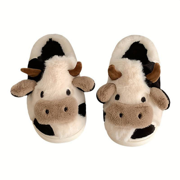 Pluche pantoffels in de vorm van een koe, met zwart-witte vlekken en hoorns. Perfect voor warme voeten en een speelse look. Ideaal als cadeau.