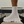 Witte enkellaars met dikke zool, gebreide schacht en modern design op zwarte stoel. Trendy damesmode, comfortabele en stijlvolle schoenen.