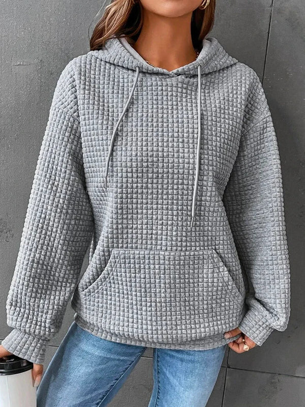 Grijze gewatteerde hoodie dames, casual stijl, met capuchon en buidelzak, comfortabele pasvorm, ideaal voor herfst en wintermode.