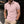 Man in roze poloshirt met korte mouwen en beige broek, leunend tegen een muur. Modieuze herenkleding, casual stijl, stedelijke achtergrond.