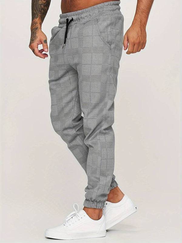 Grijze geruite joggingbroek voor heren, casual streetwear, elastische tailleband, comfortabele pasvorm, ideaal voor dagelijks gebruik en sportieve stijl.