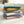 Stapel van ultra zachte bankhoezen in diverse kleuren op een crèmekleurige bank. Perfect voor interieurdecoratie en comfort.