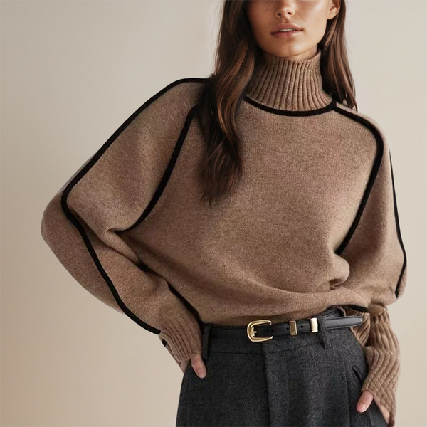 Vrouw in stijlvolle bruine coltrui met zwarte accenten, gecombineerd met grijze broek en zwarte riem. Modieuze herfstkleding, elegant design.