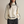 Vrouw in stijlvolle crèmekleurige coltrui met zwarte accenten, modieuze winterkleding, comfortabele damesmode, casual chique outfit.