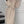 Vrouw in elegante beige gebreide jurk met knopen en ceintuur, staand op trap. Modieuze winterkleding, stijlvolle damesmode, comfortabele pasvorm.