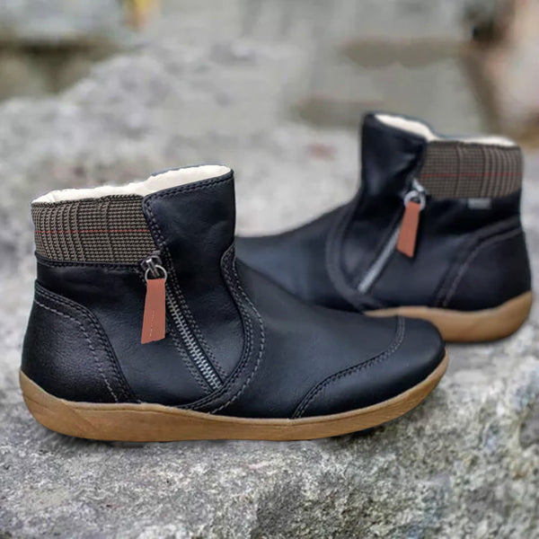 Zwarte leren enkellaarsjes met rits en bruine zool, geschikt voor dames. Comfortabele winterlaarzen, ideaal voor dagelijks gebruik en casual outfits.