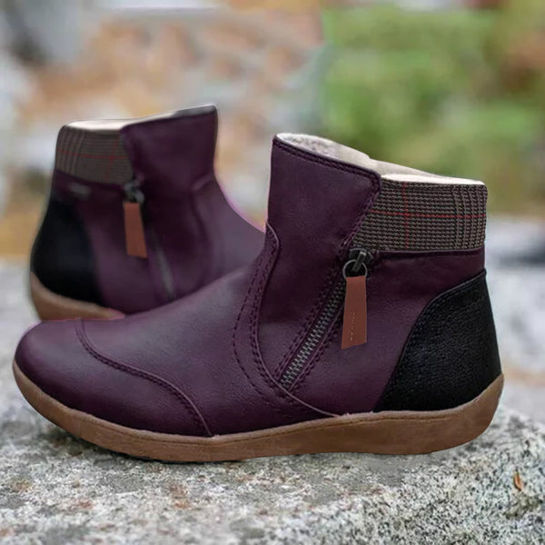 Donkerpaarse leren enkellaarsjes met rits, comfortabele zool en zwart accent, perfect voor herfstmode en casual outfits.