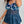 Vrouw in blauwe bloemen badpak met doorschijnende rok, strandmode, zomerkleding, trendy damesbadmode, comfortabele pasvorm, casual stijl.