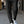 Zwarte broek met scherpe vouw, gedragen met witte sneakers. Stijlvolle mode voor dames, perfect voor casual en zakelijke outfits.