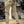 Beige cargobroek met meerdere zakken, gedragen door persoon in winkel. Outdoor laarzen en casual kleding. Mode, herenkleding, urban stijl.