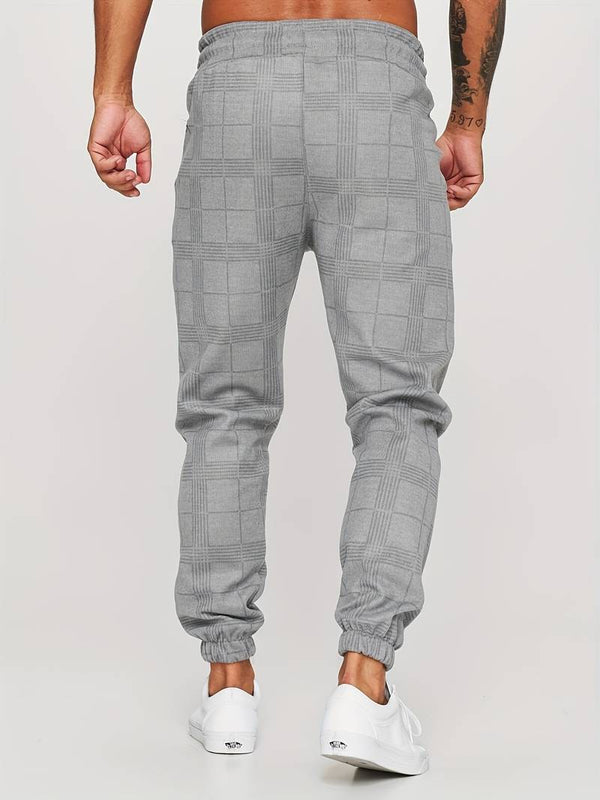 Grijze geruite joggingbroek voor heren, comfortabele pasvorm, casual streetwear, elastische tailleband, modieuze herenkleding.