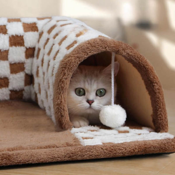 Pluche kattenbed en tunnel in één, bruin-wit geruit ontwerp met speeltje, ideaal voor kattencomfort en spel. Perfect voor huisdieraccessoires.