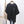 Zwarte dames T-shirt met lachend gezichtje, casual stijl, korte mouwen, katoenen stof, opgehangen aan houten hanger, naast canvas tas.