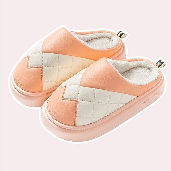 Zachte, warme pantoffels met een gewatteerd ruitpatroon in perzik en wit, ideaal voor thuiscomfort. Perfecte winterse huisschoenen voor dames.