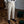Beige pantalon voor heren, elegant geplooid, gedragen met zwarte loafers. Perfect voor formele gelegenheden. Stijlvolle herenkleding.