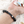 Zwart lavasteen armband met metalen pijlen, olie diffuser functie, hand op witte achtergrond, ideaal voor aromatherapie en stijlvol accessoire.