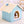 Pluche hondenhuisje in pastelblauw met beige dak, comfortabele slaapplaats voor kleine honden, perfect voor binnengebruik.
