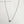 Zilveren ketting met hartvormige hanger op witte achtergrond, minimalistisch design, perfect voor cadeau, sieraden uit Seattle, USA.