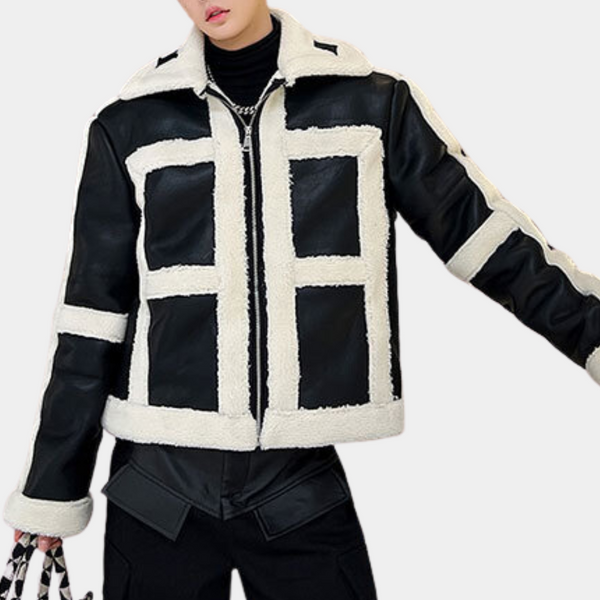 Zwart-witte shearling jas voor dames, trendy wintermode, met rits en contrasterende panelen, ideaal voor stijlvolle en warme outfits.