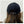 Zwarte fleece pet met verstelbare riem, gedragen door persoon met lang bruin haar. Stijlvolle winteraccessoire, unisex design.