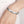 Zilveren armband met lotusgravure op pols, elegant en stijlvol design, perfect voor damesmode en sieradencollecties.