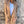 Vrouw in beige blazer en witte top tegen verweerde muur, modieuze herfstkleding, casual chic stijl, trendy damesmode, buitenfotografie.