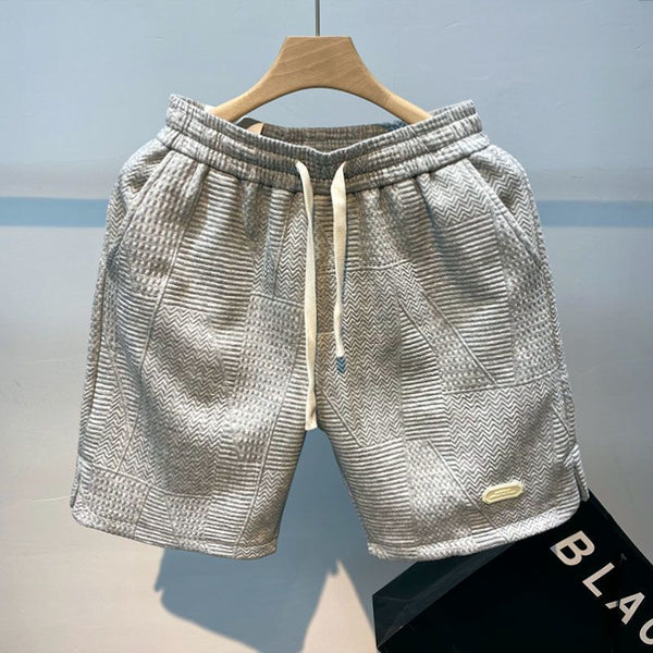 Grijze sportshorts voor heren met golfpatroon, trekkoord en zakken, ideaal voor hardlopen en casual sporten. Comfortabele en stijlvolle pasvorm.